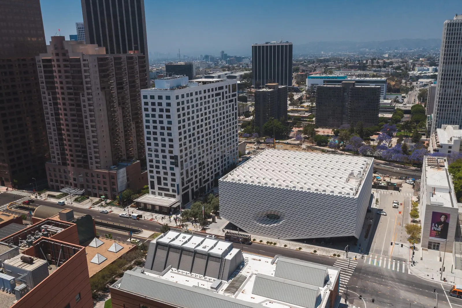 Aerial drone shot capturing the iconic architecture of downtown Los Angeles, featuring The Broad museum.